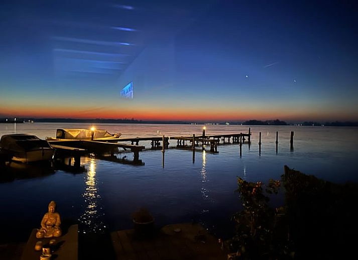 Geniessen Sie den Sonnenuntergang im Ferienhaus in Loosdrecht, Nordholland, mit Blick auf das Wasser von der Veranda aus.