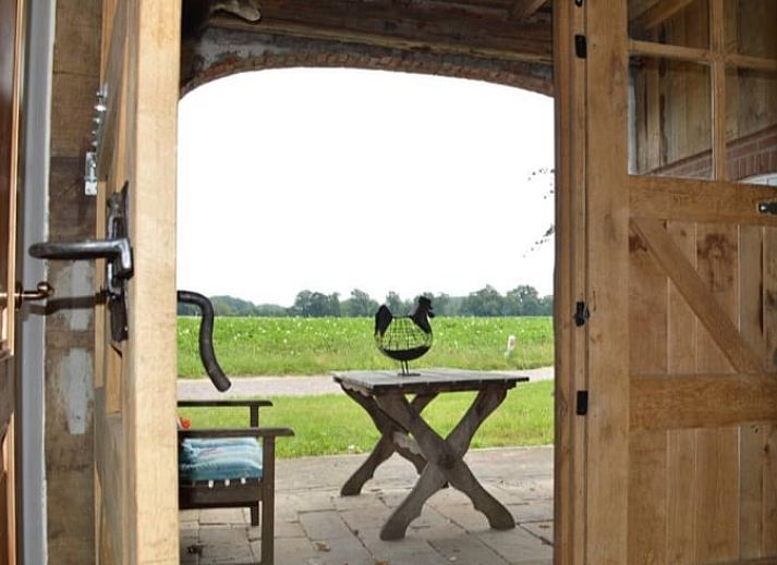 Gezellige eetkamer in vakantiehuisje in Mander, Twente, met houten interieur en lange tafel.
