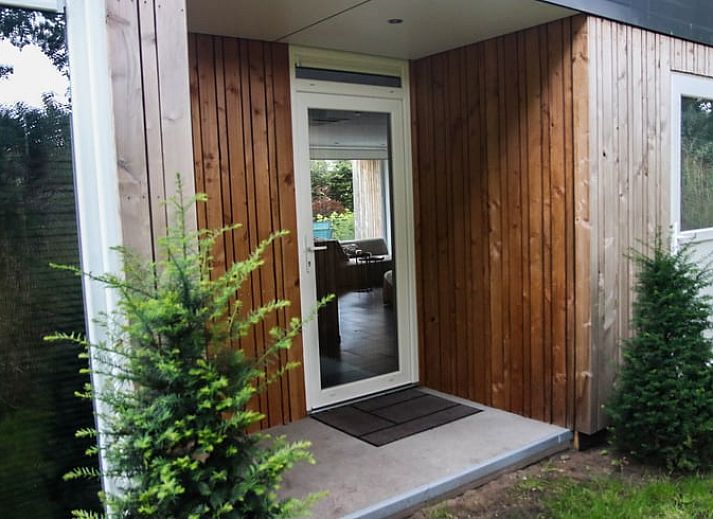 Cozy living room in Holiday Home in Den Ham, Twente, with comfortable seating area and views of the nature of Overijssel.