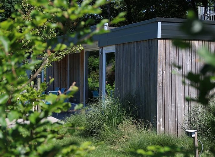 Cozy living room in Holiday Home in Den Ham, Twente, with comfortable seating area and views of the nature of Overijssel.
