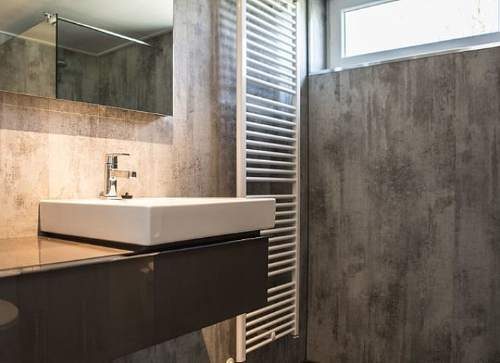 Cozy living room of cottage in Den Ham, Twente, with modern furnishings and comfortable seating area in Overijssel.