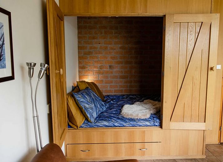 Cozy living room of cottage in Den Ham, Twente. Vacation home with cozy sitting area and kitchen in Overijssel nature.