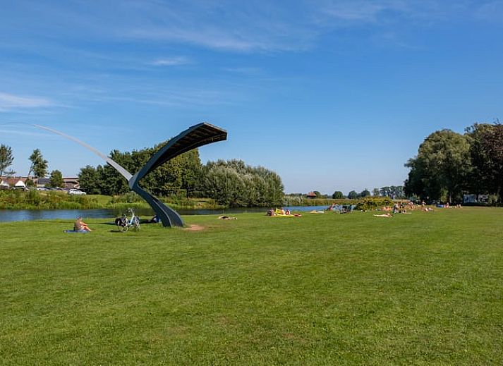 Family enjoys a game on the terrace of Huisje in Den Ham, a vacation home in green Twente, Overijssel.