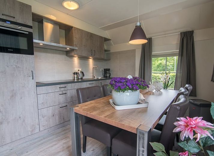 Charming vacation home in Den Ham, Twente, Overijssel, surrounded by autumn trees and rustic nature, ideal for a relaxing stay.