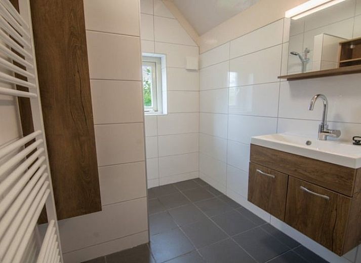 Cozy living room in Holiday Home in Den Ham, Twente, Overijssel with comfortable sofas and views of the green surroundings.