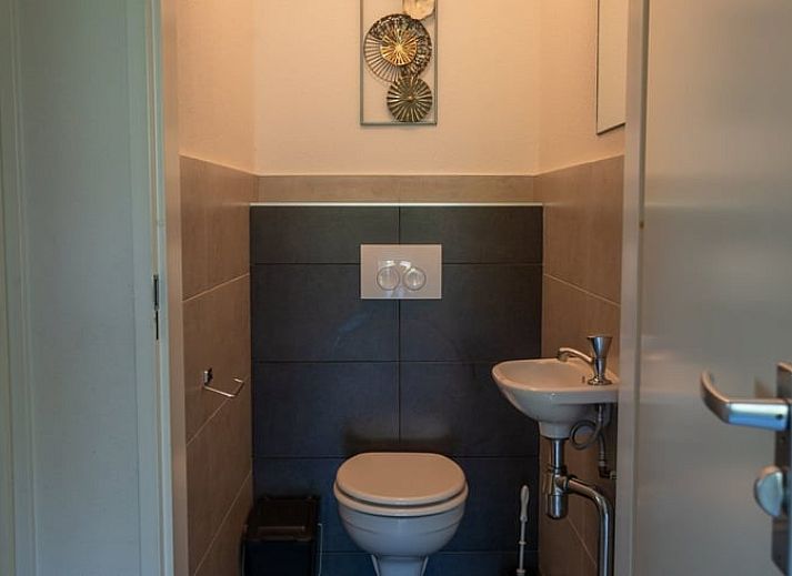 Cozy living room in Holiday Home in Den Ham, Twente, Overijssel with comfortable sofas and views of the green surroundings.