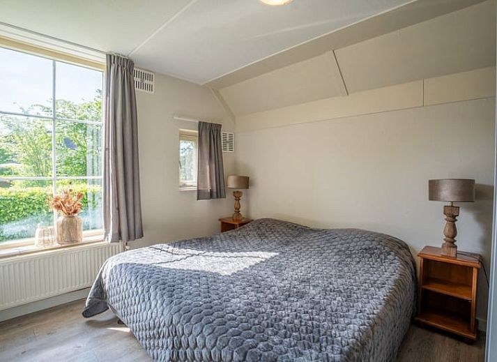 Cozy living room in Holiday Home in Den Ham, Twente, Overijssel with comfortable sofas and views of the green surroundings.
