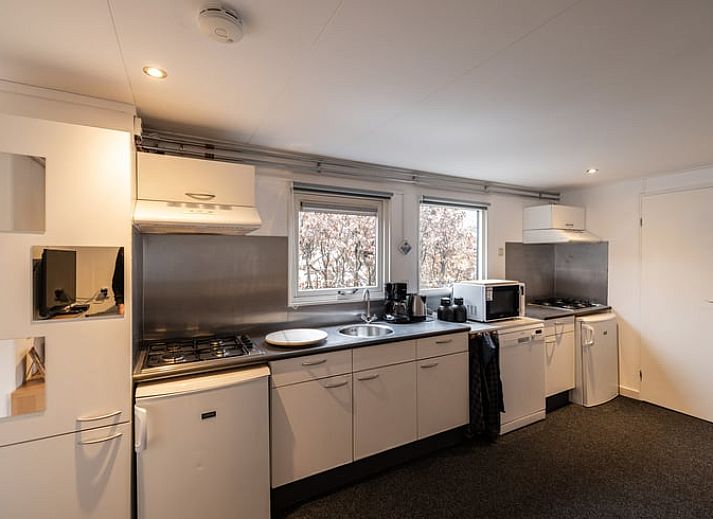 Gezellige woonkamer van Vakantiehuis in Den Ham, Twente, Overijssel met comfortabele zithoek en ruime eethoek voor een ontspannen verblijf.