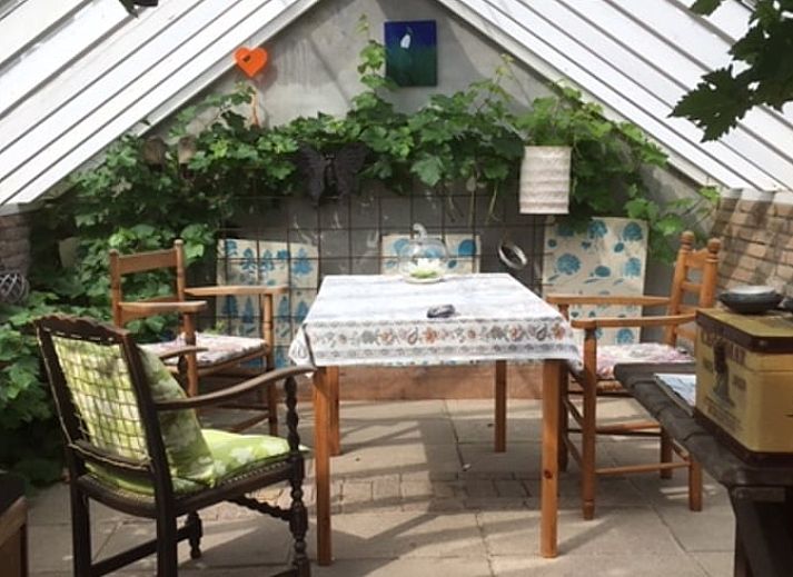 Cozy porch of Cottage in De Lutte, Twente, Overijssel, with comfortable chairs and country charm.