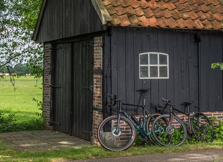 Attractive bedroom in cottage in Beuningen, Twente with wooden interior and modern bathroom.