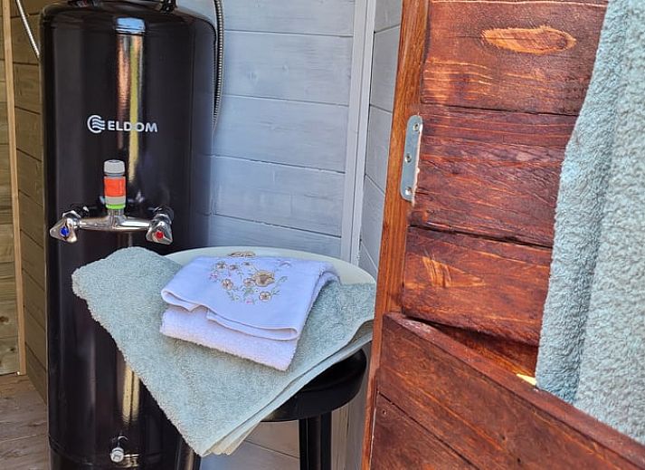 Charming exterior of Holiday home in Overdinkel, Twente, with wooden terrace and garden furniture.