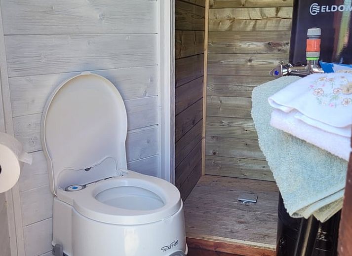Charming exterior of Holiday home in Overdinkel, Twente, with wooden terrace and garden furniture.