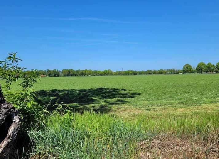 Cozy indoor area of Holiday Home in Overdinkel, Twente, with comfortable sitting area and bed.