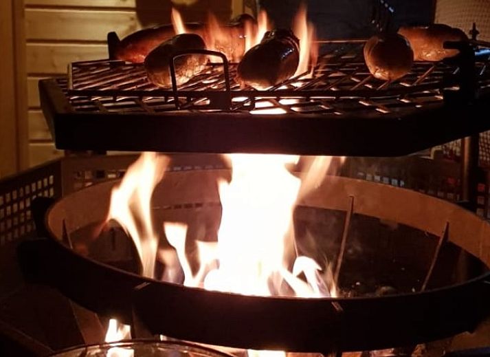 Cozy indoor area of Holiday Home in Overdinkel, Twente, with comfortable sitting area and bed.