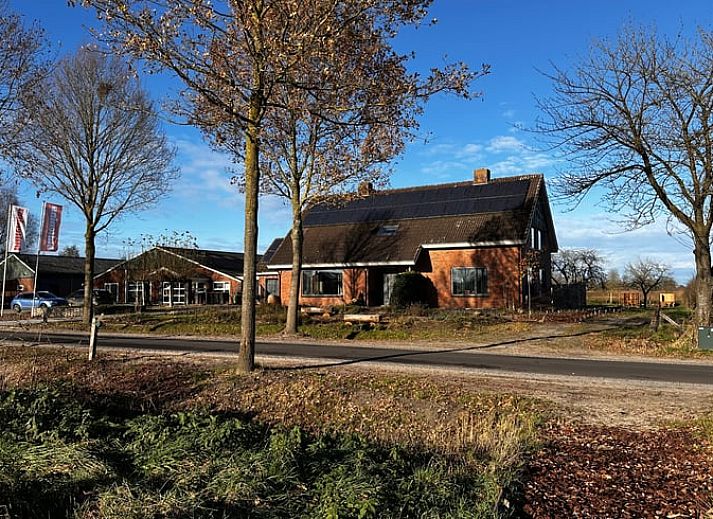 Open space with wooden floor and stairs in Cottage in Rijssen, vacation accommodation in Twente, Overijssel.