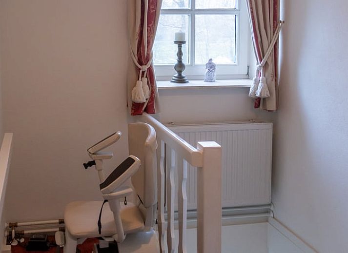 Cozy living room in Cottage in Oldenzaal vacation home in Twente, Overijssel with comfortable chairs.