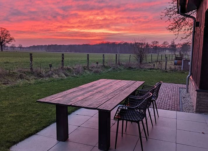 Bright dining room in Holiday home in Markelo, Twente overlooking the garden.