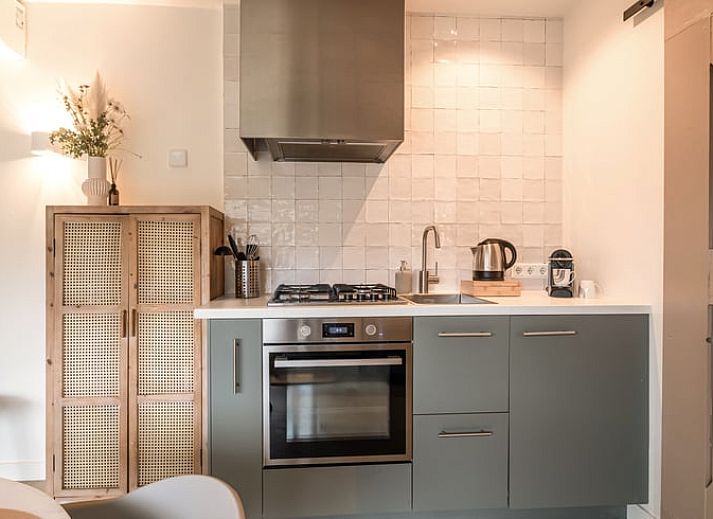 Gezellige woonkamer in Vakantiehuis in Usselo, Twente, met uitzicht op het terras en groene omgeving.