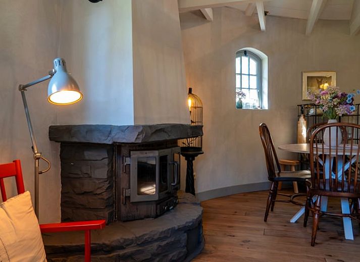 Cozy indoor area of Holiday cottage in Denekamp, Twente, with flowers on the table, ideal place for relaxing moments.