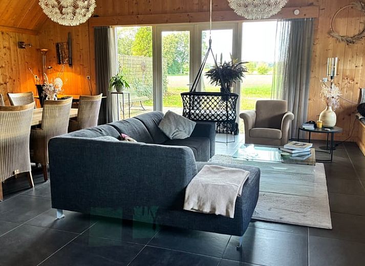 Charming cottage in Denekamp, Twente, with wooden facade and red roof tiles. Perfect vacation home in Overijssel.