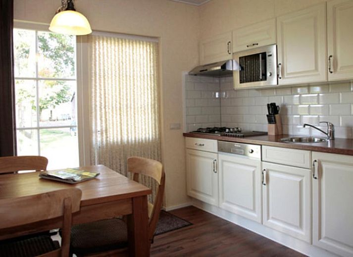 Huisje in Notter, vakantiehuis in Twente, omgeven door groene natuur en grazende paarden.