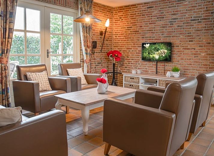 Cozy indoor area of Holiday Home in Losser, Twente, with a beautiful view of the green surroundings from the living room.