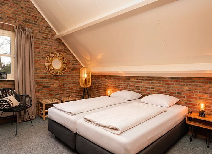 Cozy living room in Holiday Home in Losser, Twente, Overijssel with comfortable sofas and garden view.