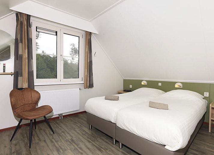 Cozy living room in Boshuus Comfort Plus vacation home in Deurningen, Twente, overlooking green nature.