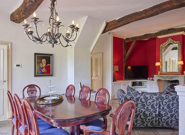 Cozy living room of Erve Het Klaashuis vacation home in Deurningen, Twente, with authentic wooden beams and warm furnishings.