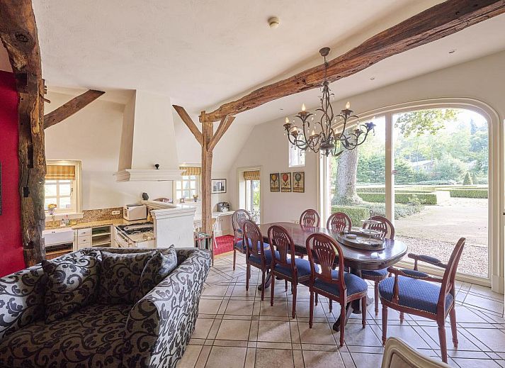 Cozy living room of Erve Het Klaashuis vacation home in Deurningen, Twente, with authentic wooden beams and warm furnishings.