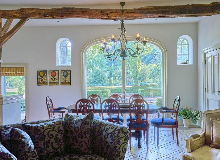 Cozy living room of Erve Het Klaashuis vacation home in Deurningen, Twente, with authentic wooden beams and warm furnishings.