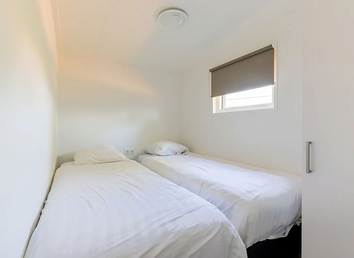 Gemuetliches Wohnzimmer des Ferienhauses Linde 6 in Hoge Hexel, Twente mit Blick auf die Terrasse und die gruene Umgebung in Overijssel.