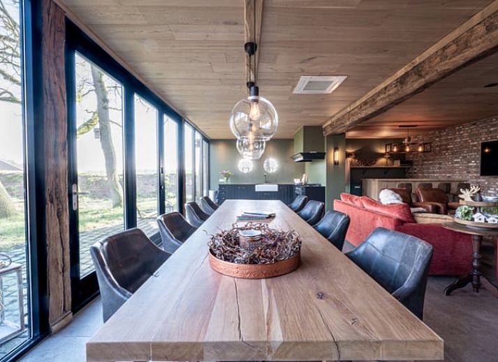 Spacious living room in Holiday Home in Glane, Twente with wooden ceiling and modern furnishings.