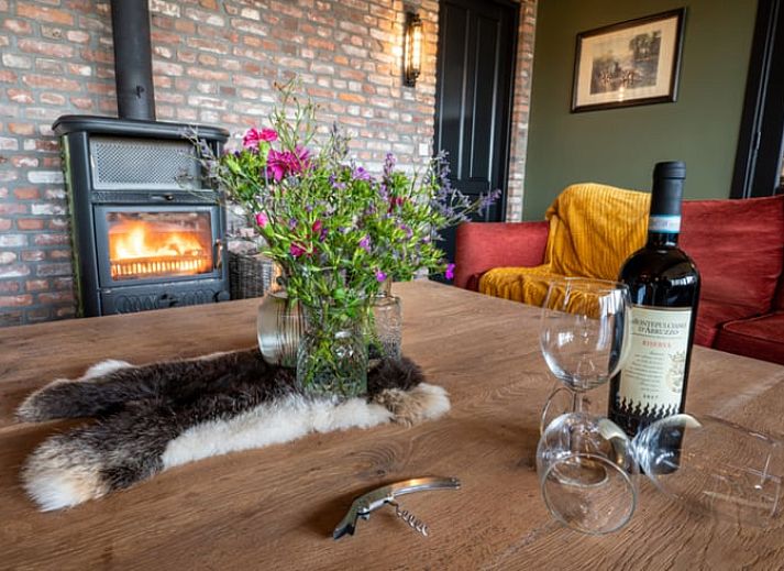 Spacious living room in Holiday Home in Glane, Twente with wooden ceiling and modern furnishings.