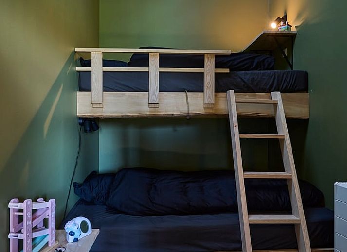 Stylish bar in Holiday Home in Glane, Twente with wooden stools and mood lighting.