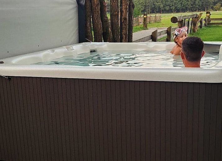 Stylish bar in Holiday Home in Glane, Twente with wooden stools and mood lighting.