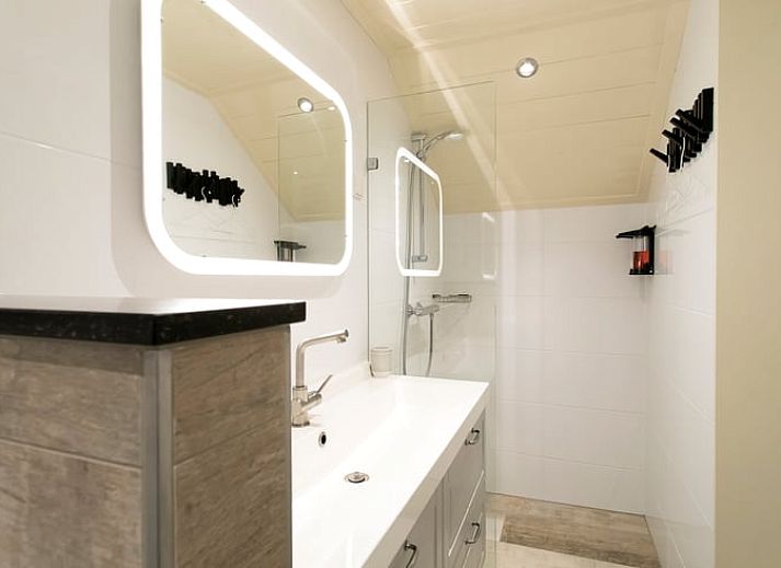 Stilvoller Innenraum im Ferienhaus in Boekelo, Enschede, mit bequemen Stuehlen und einer rustikalen Truhe.