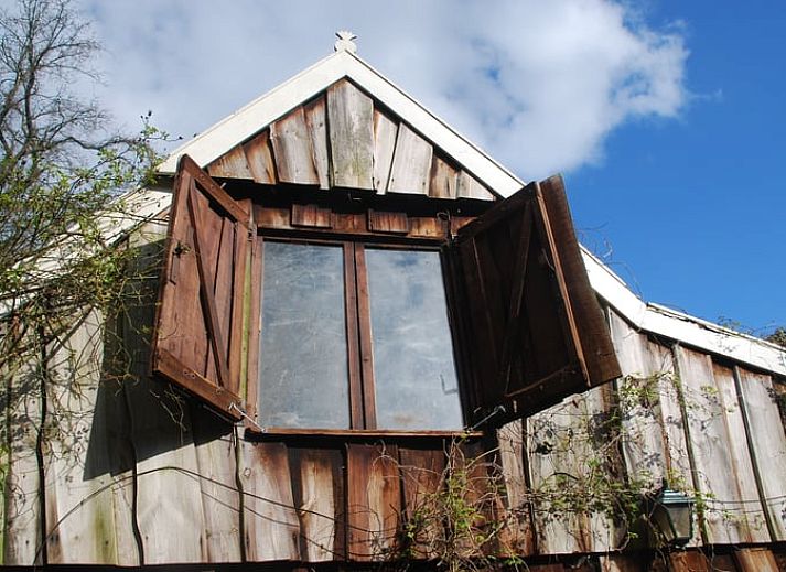 Rustieke vakantiewoning in Boekelo, Enschede met rode dakpannen, ideaal gelegen tussen weelderige bomen in het hart van Twente.