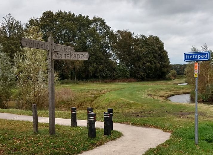 Cozy interior of cottage in Bornerbroek, Twente, with wooden interior and comfortable seating area.
