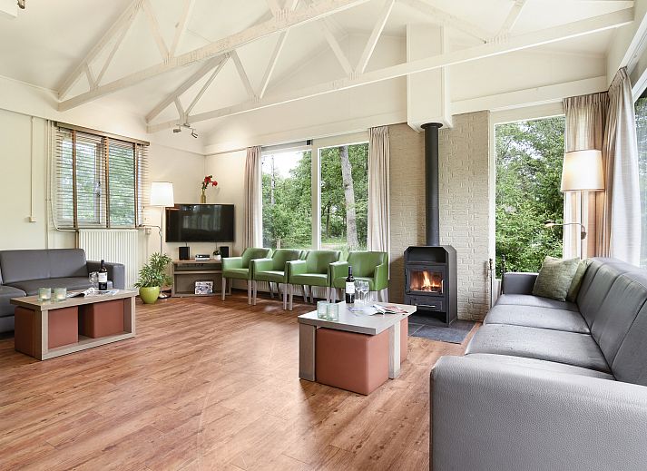 Gemuetliche Sitzecke mit Kamin im Wiedervereinigungsbungalow Twenhaarsveld in Overijssel.