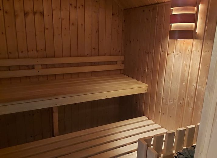 Ferienhaus in Holten, gelegen in der gruenen Natur von Salland, Overijssel, umgeben von bunten Blumen und einem ueppigen Garten.