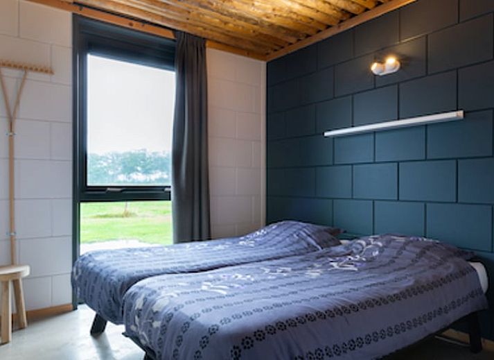 Gezellige woonkamer in Vakantiehuisje in Heeten, Salland, met open keuken en houten plafond.