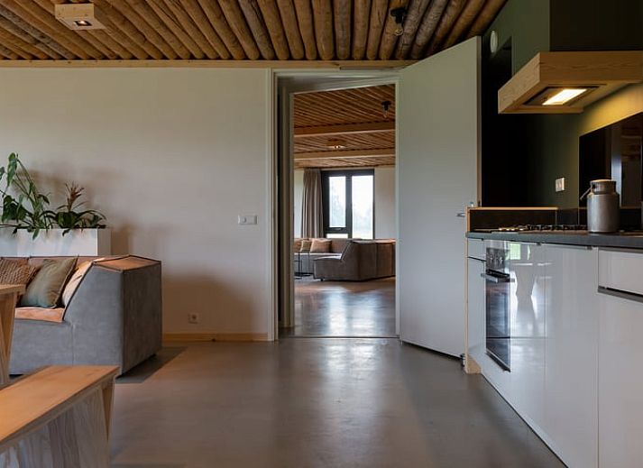 Spacious sitting area in Cottage in Heeten with large windows, ideal for a stay in Salland, Overijssel.