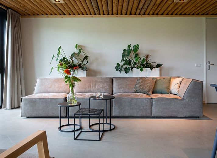 Spacious sitting area in Cottage in Heeten with large windows, ideal for a stay in Salland, Overijssel.