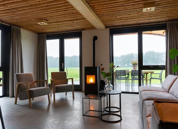Spacious sitting area in Cottage in Heeten with large windows, ideal for a stay in Salland, Overijssel.