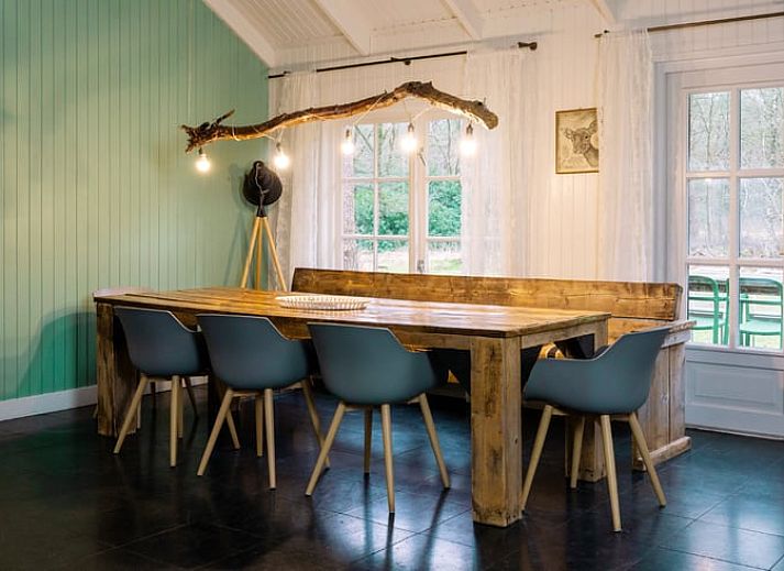 Covered table on the terrace of Holiday home in Okkenbroek, Salland, ideal for a relaxing meal in the nature of Overijssel.
