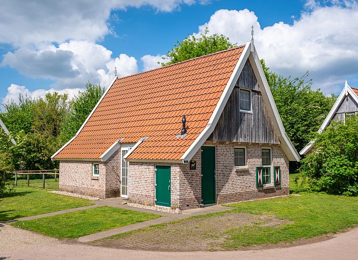 Knusse zithoek in Landgoed De Hellendoornse Berg kinderbungalow, Haarle, Overijssel, met wijn en glazen.
