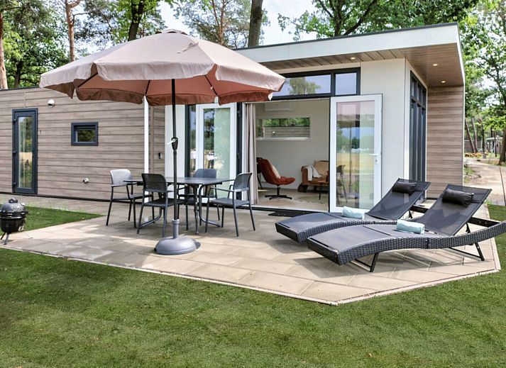 Enjoy the terrace at vacation home OV751 in Haarle, Hellendoorn, Overijssel, surrounded by nature and with comfortable deck chairs.