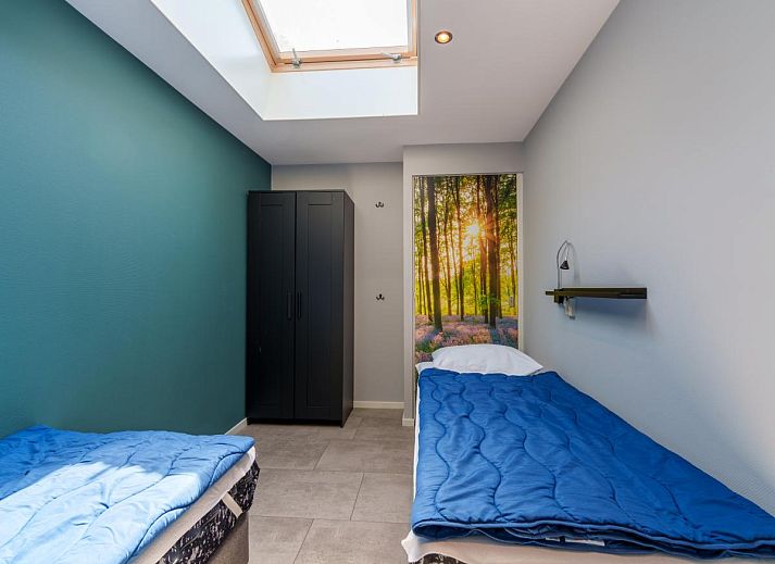 Gezellig terras bij vakantiehuis Reggezicht in Marle, Salland, Overijssel, omringd door groene natuur.