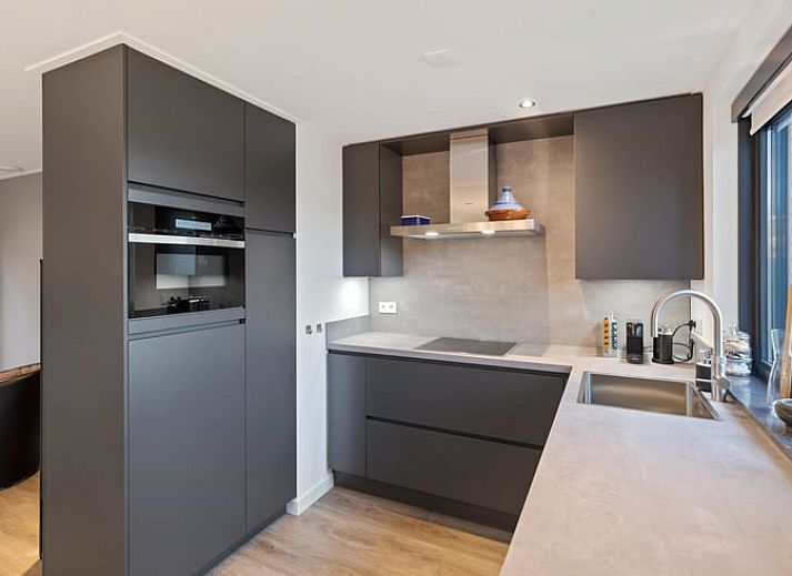 Enjoy the serene wooded garden of Holiday Home in Ommen, located in the Vecht region, Overijssel, with atmospheric lighting on the terrace.